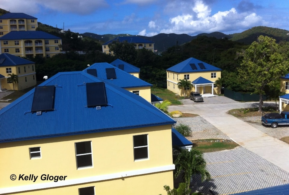 VI Housing Finance Department units with solar hot water collectors on blue metal roofs
