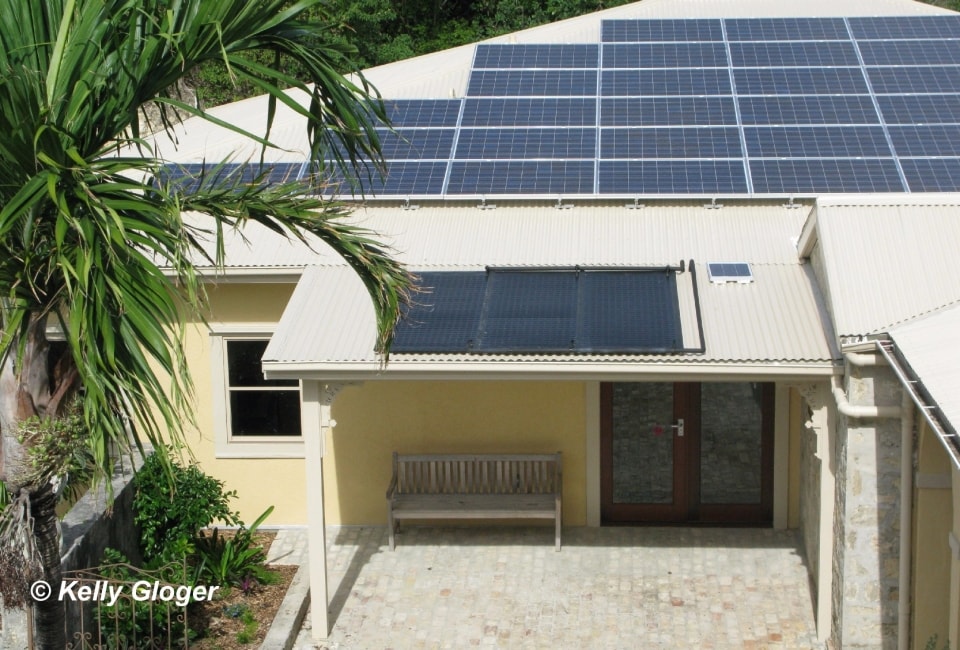 Residential solar hot water installation on roof with neighborhood view