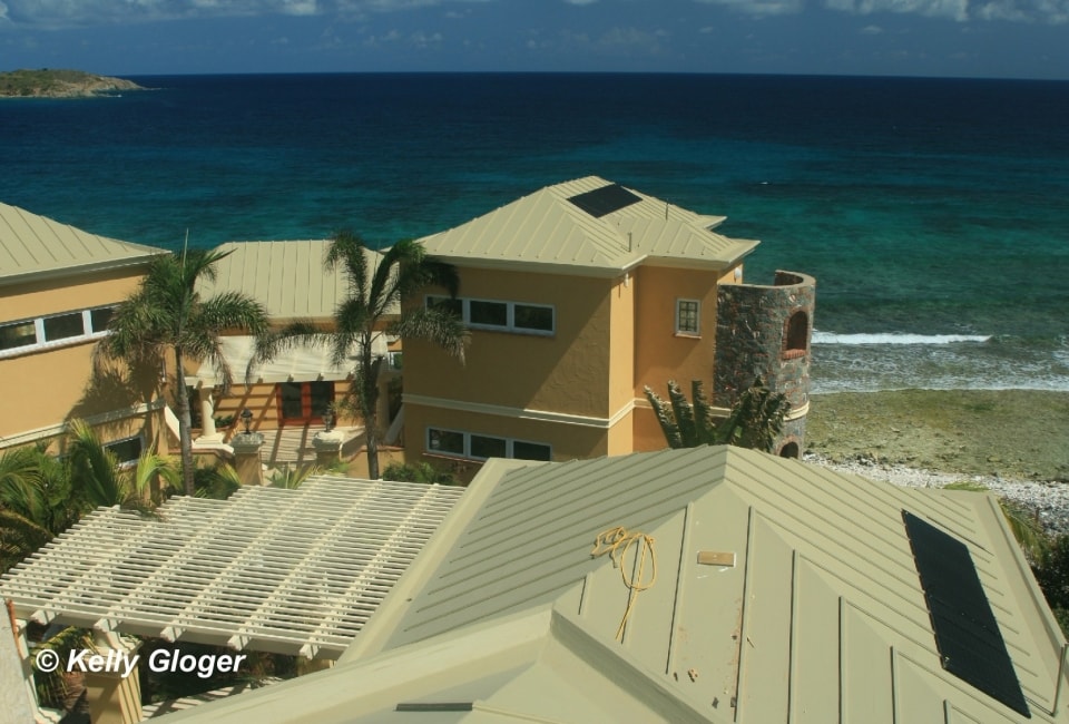 Beachfront residence with solar hot water panels overlooking Caribbean sea