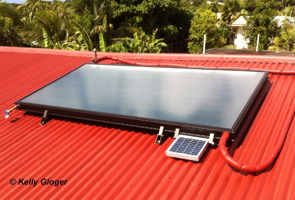 Solar hot water collector with pump module on red corrugated roof
