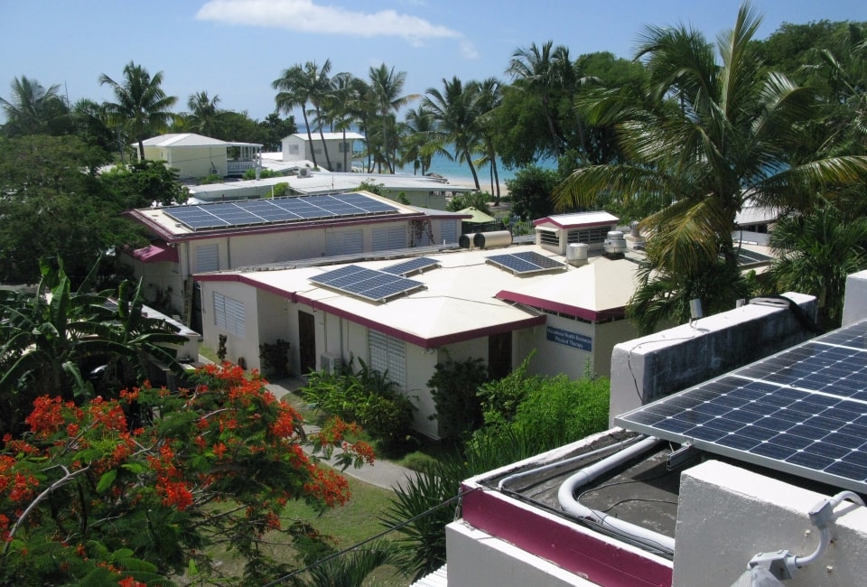 Sand Castle Hotel buildings with solar panels and tropical setting